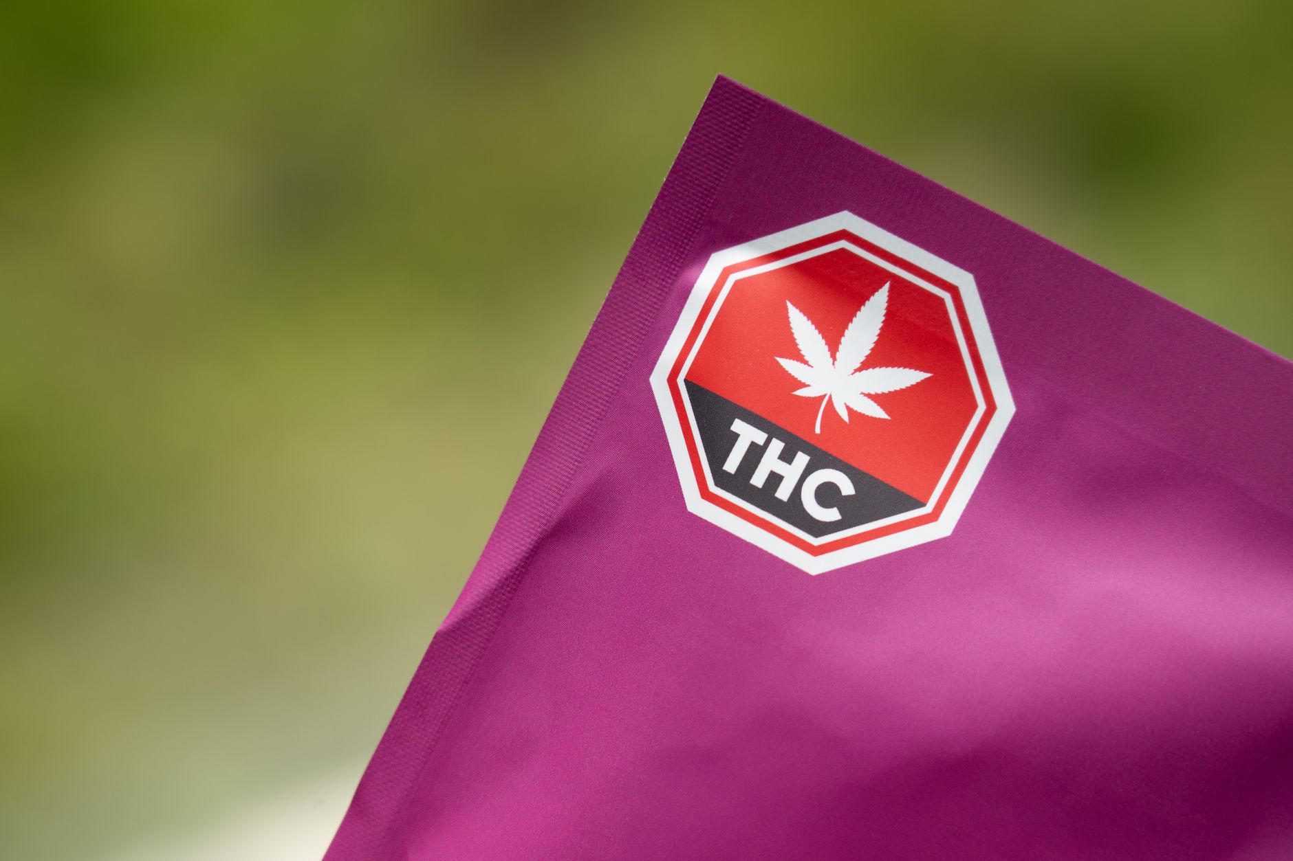 purple thc cannabis packaging with warning symbol